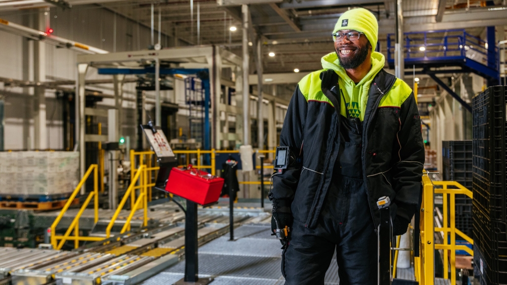 Lineage worker smiling in cold storage facility