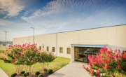 Photo of main entrance to Decatur, AL facility with flowers in bloom