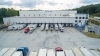 Front view of Lineage’s Lithia Springs cold storage facility in Atlanta, featuring multiple trucks docked at loading bays, emphasizing its logistics capabilities.