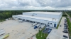 Aerial view of Lineage’s Doolittle facility in Jacksonville, featuring multiple loading docks, parked trucks and a spacious outdoor area with greenery.